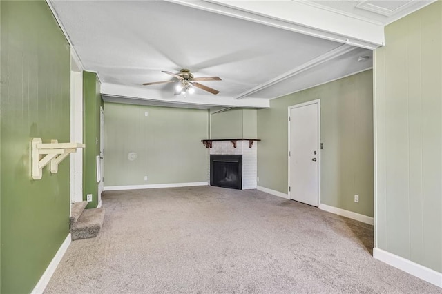 906 W 84th St, Kansas City, MO 64114 - unfurnished living room featuring carpet floors, ceiling fan, a brick fireplace, and baseboards