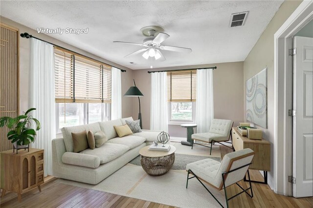 906 W 84th St, Kansas City, MO 64114 - living area with a ceiling fan and wood finished floors