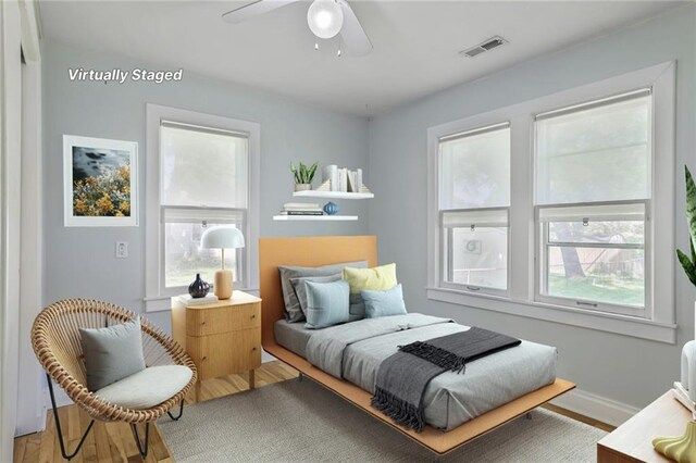 906 W 84th St, Kansas City, MO 64114 - bedroom featuring wood finished floors, a ceiling fan, and baseboards