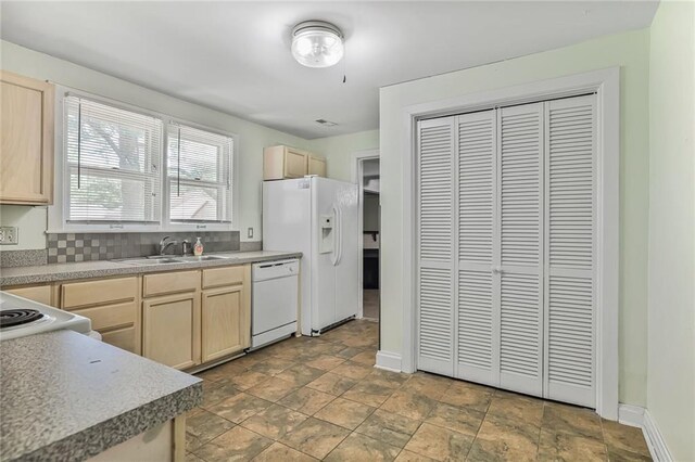906 W 84th St, Kansas City, MO 64114 - kitchen featuring white appliances, light brown cabinetry, a sink, stone finish flooring, and baseboards