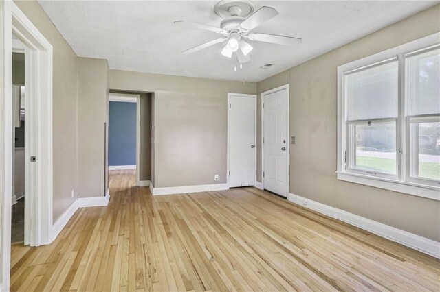 906 W 84th St, Kansas City, MO 64114 - empty room featuring light wood finished floors, baseboards, and a ceiling fan