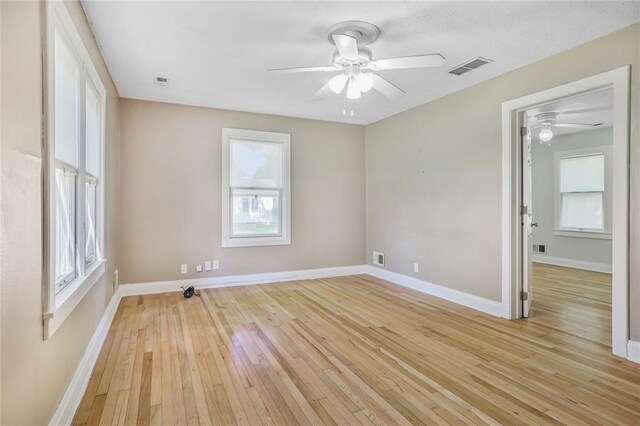 906 W 84th St, Kansas City, MO 64114 - spare room featuring a ceiling fan, light wood-style flooring, and baseboards