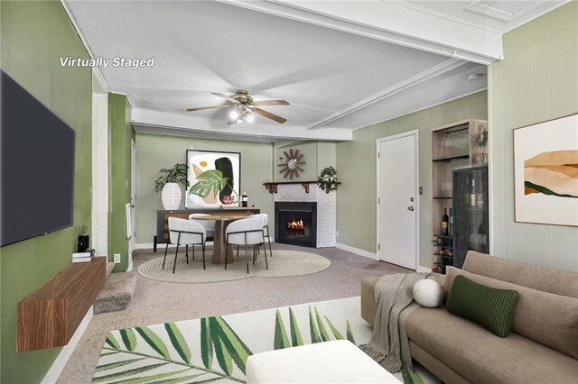 906 W 84th St, Kansas City, MO 64114 - carpeted living room featuring a brick fireplace, a ceiling fan, and baseboards