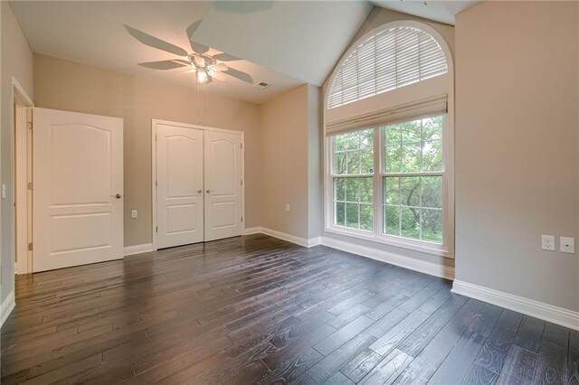5437 W 145th Ter, Leawood, KS 66224 - unfurnished bedroom with baseboards, dark wood-type flooring, a closet, a ceiling fan, and lofted ceiling