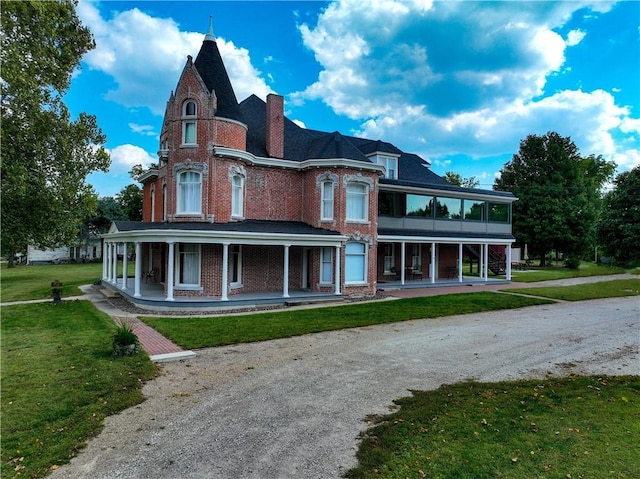 433 W State St, Troy, KS 66087 - rear view of property featuring a porch, brick siding, a lawn, and a chimney