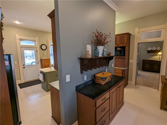 433 W State St, Troy, KS 66087 - hallway featuring light carpet, baseboards, and a sink