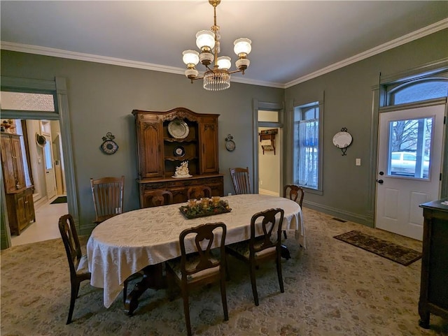 433 W State St, Troy, KS 66087 - carpeted dining area with a chandelier, crown molding, and baseboards
