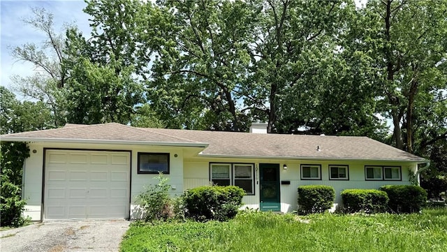 10711 Bennington Ave, Kansas City, MO 64134 - single story home featuring an attached garage, asphalt driveway, a chimney, and a shingled roof