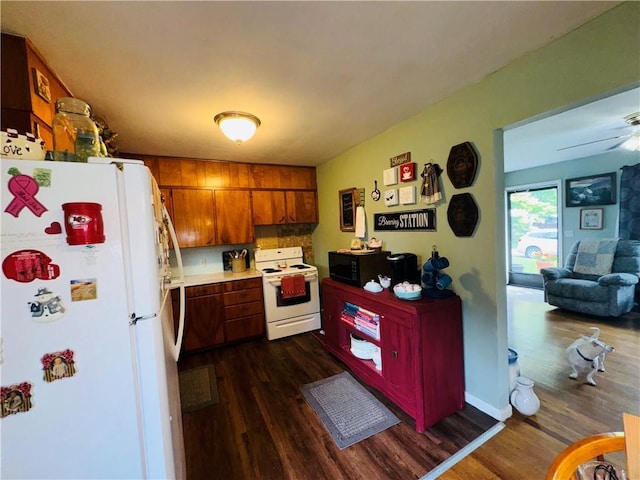 310 E Monroe Ave, Garnett, KS 66032 - kitchen with white appliances, dark wood-type flooring, brown cabinetry, light countertops, and a ceiling fan