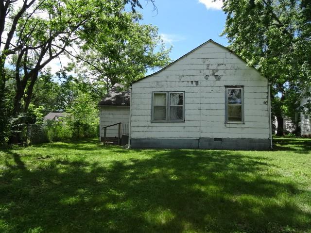 309-311 N Lyon St, Butler, MO 64730 - view of side of property with a yard and crawl space