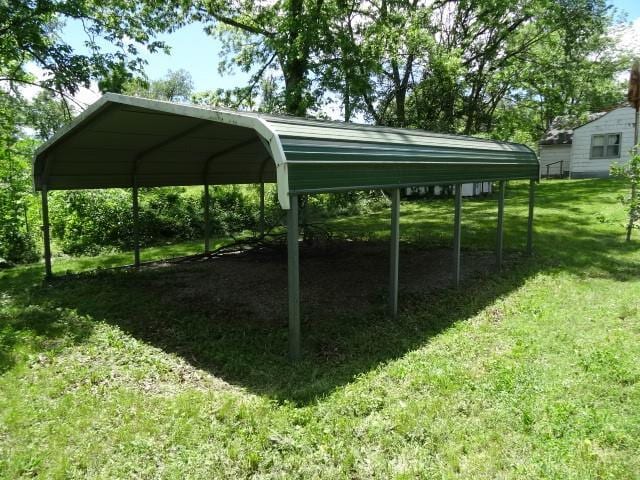 309-311 N Lyon St, Butler, MO 64730 - view of vehicle parking with a carport
