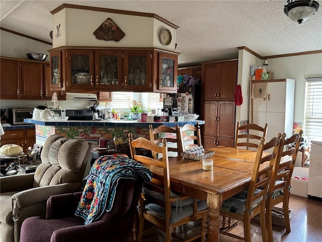 476 170th St, Fort Scott, KS 66701 - dining space with ornamental molding, a textured ceiling, and wood finished floors