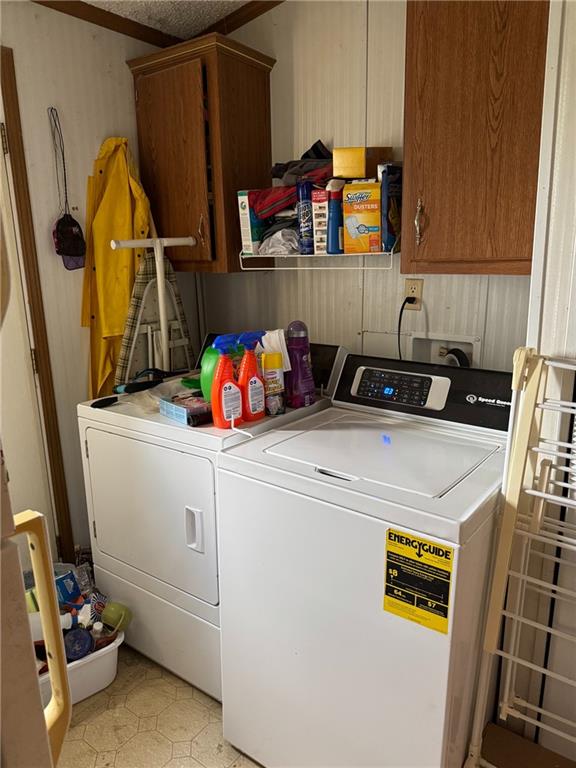 476 170th St, Fort Scott, KS 66701 - laundry room featuring washing machine and clothes dryer and cabinet space
