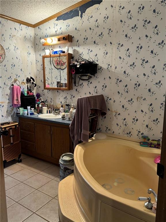 476 170th St, Fort Scott, KS 66701 - full bathroom featuring wallpapered walls, ornamental molding, tile patterned floors, a textured ceiling, and a garden tub