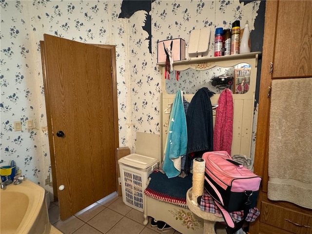 476 170th St, Fort Scott, KS 66701 - bathroom featuring wallpapered walls, tile patterned floors, and a bath
