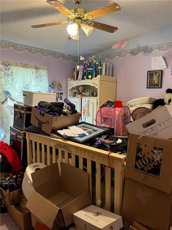 476 170th St, Fort Scott, KS 66701 - bedroom featuring a textured ceiling and a ceiling fan