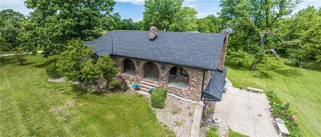 1747 SW County Road Tt Hwy, Holden, MO 64040 - view of front facade featuring a front yard, a chimney, roof with shingles, and a porch