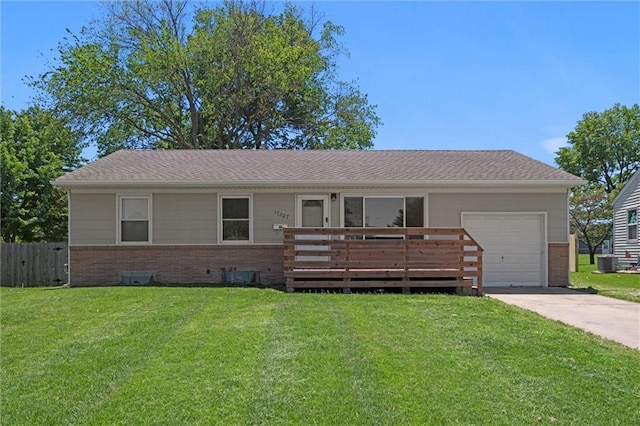 17207 E Swope Ln, Independence, MO 64056 - ranch-style house featuring brick siding, a garage, driveway, cooling unit, and a wooden deck
