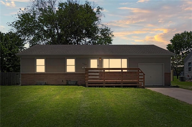 17207 E Swope Ln, Independence, MO 64056 - view of front of property with brick siding, concrete driveway, a garage, and cooling unit