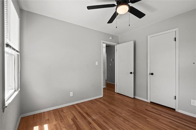 17207 E Swope Ln, Independence, MO 64056 - unfurnished bedroom featuring wood finished floors, baseboards, and a ceiling fan