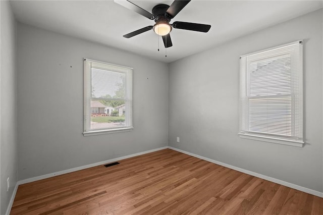 17207 E Swope Ln, Independence, MO 64056 - empty room with wood finished floors, baseboards, and ceiling fan