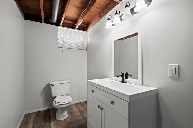 17207 E Swope Ln, Independence, MO 64056 - half bathroom with toilet, vanity, wood finished floors, and baseboards