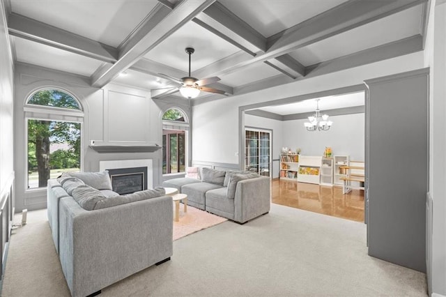 6221 W 126th Ter, Overland Park, KS 66209 - carpeted living room featuring a fireplace, a chandelier, beamed ceiling, coffered ceiling, and ceiling fan