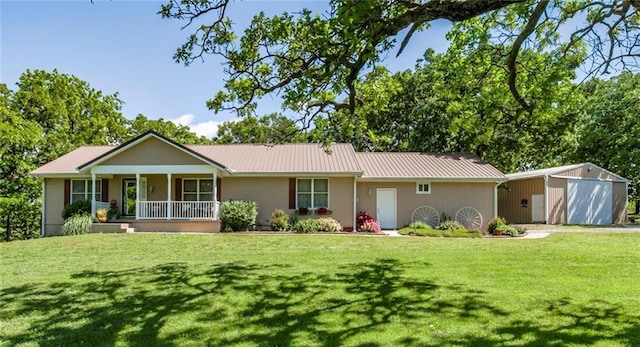 1375 Labette Rd, Ottawa, KS 66067 - view of front of property featuring a front lawn, a porch, metal roof, an outbuilding, and a garage