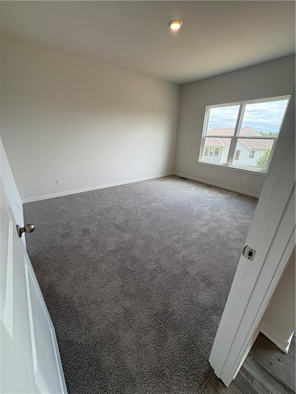 19605 W 200th St, Spring Hill, KS 66083 - empty room featuring dark carpet and baseboards