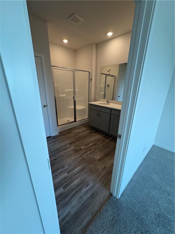 19605 W 200th St, Spring Hill, KS 66083 - full bathroom featuring a shower stall, vanity, wood finished floors, recessed lighting, and baseboards