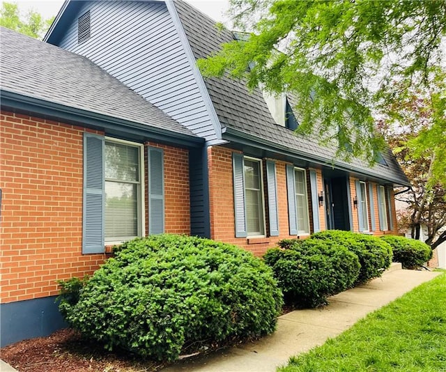 13106 E 57th St, Kansas City, MO 64133 - view of side of property featuring brick siding and a shingled roof