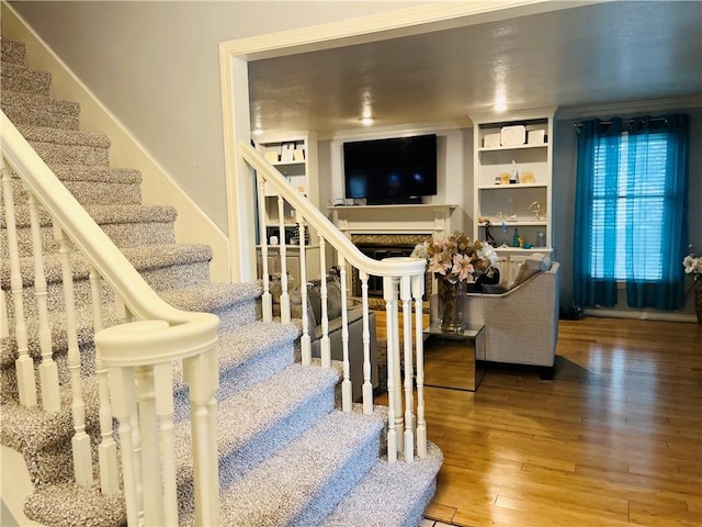 13106 E 57th St, Kansas City, MO 64133 - stairs featuring wood-type flooring and a fireplace