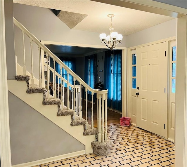 13106 E 57th St, Kansas City, MO 64133 - foyer entrance with stairway, a chandelier, and brick patterned floors
