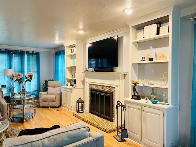 13106 E 57th St, Kansas City, MO 64133 - living area featuring light wood-style flooring, a glass covered fireplace, ornamental molding, and built in features