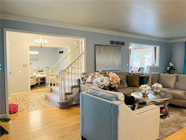 13106 E 57th St, Kansas City, MO 64133 - living area featuring light wood finished floors, a chandelier, crown molding, stairs, and baseboards