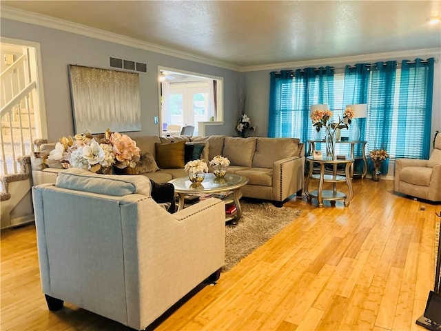 13106 E 57th St, Kansas City, MO 64133 - living area with ornamental molding and light wood-style floors