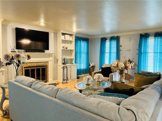 13106 E 57th St, Kansas City, MO 64133 - living room with crown molding, light wood-style flooring, and a glass covered fireplace
