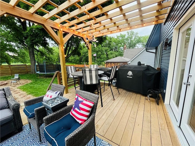 13106 E 57th St, Kansas City, MO 64133 - wooden terrace with a trampoline, outdoor dining area, grilling area, outdoor lounge area, and a pergola