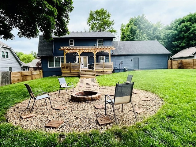 13106 E 57th St, Kansas City, MO 64133 - rear view of house with a fire pit, a pergola, a deck, and a shingled roof