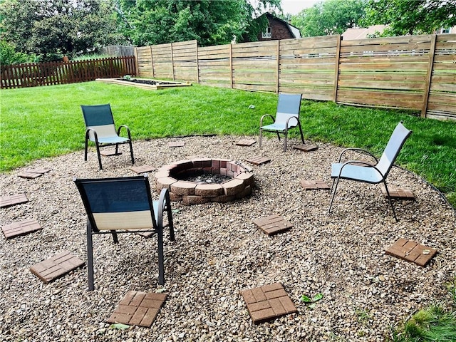 13106 E 57th St, Kansas City, MO 64133 - view of yard featuring a fire pit