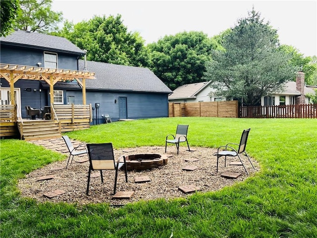 13106 E 57th St, Kansas City, MO 64133 - view of yard with a fire pit, a pergola, and a wooden deck