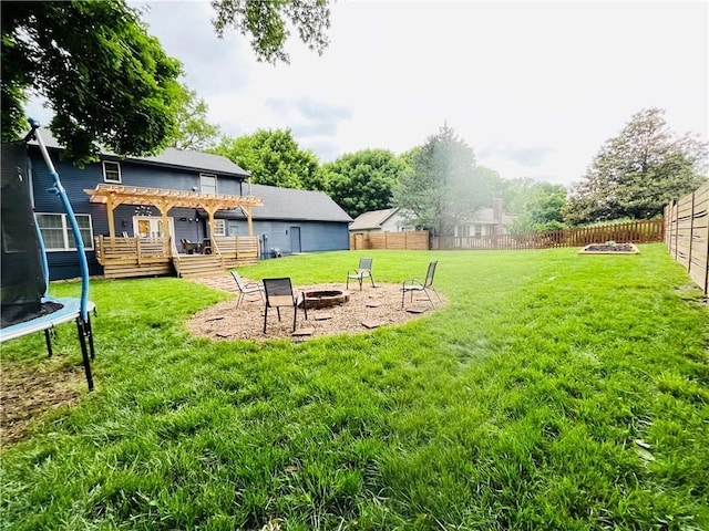 13106 E 57th St, Kansas City, MO 64133 - view of yard with a trampoline, an outdoor fire pit, and a pergola
