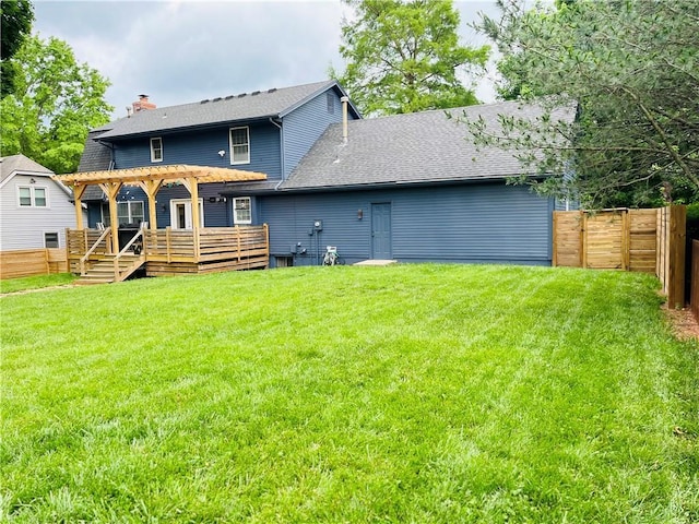 13106 E 57th St, Kansas City, MO 64133 - rear view of house featuring a wooden deck, a pergola, a shingled roof, and a chimney