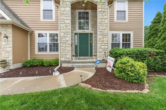 800 Ash Ct, Lansing, KS 66043 - doorway to property featuring stone siding