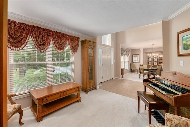 800 Ash Ct, Lansing, KS 66043 - entryway featuring a chandelier, ornamental molding, light carpet, and baseboards