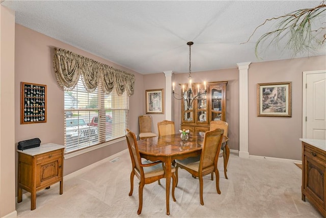 800 Ash Ct, Lansing, KS 66043 - dining space with a chandelier, decorative columns, baseboards, light carpet, and a textured ceiling