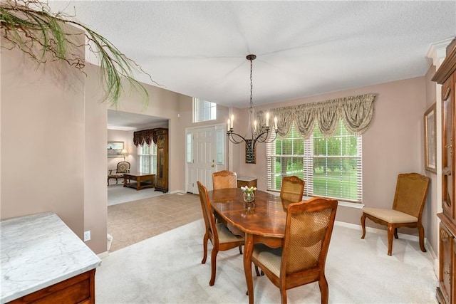 800 Ash Ct, Lansing, KS 66043 - dining space with a chandelier, baseboards, light carpet, and a textured ceiling