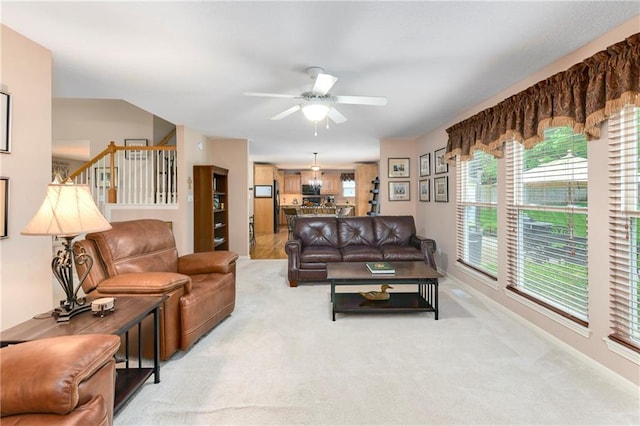 800 Ash Ct, Lansing, KS 66043 - living area with a ceiling fan, light colored carpet, and stairs