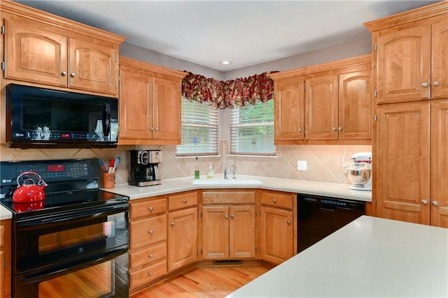 800 Ash Ct, Lansing, KS 66043 - kitchen featuring black appliances, light countertops, a sink, backsplash, and recessed lighting