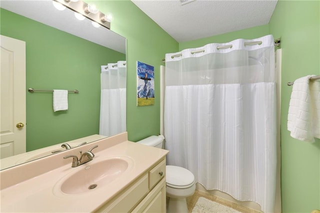 800 Ash Ct, Lansing, KS 66043 - bathroom with toilet, vanity, tile patterned floors, a textured ceiling, and curtained shower